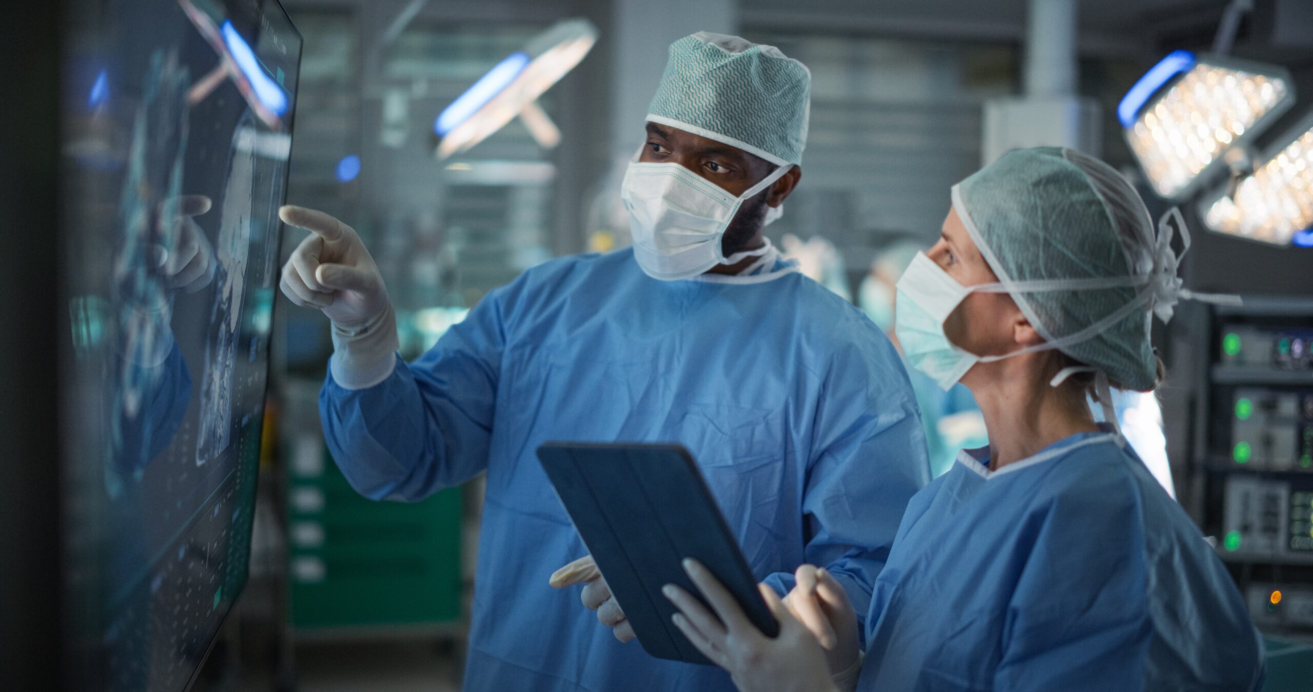 Female,Surgeon,Intently,Studies,Brain,Imaging,On,A,Big,Monitor,